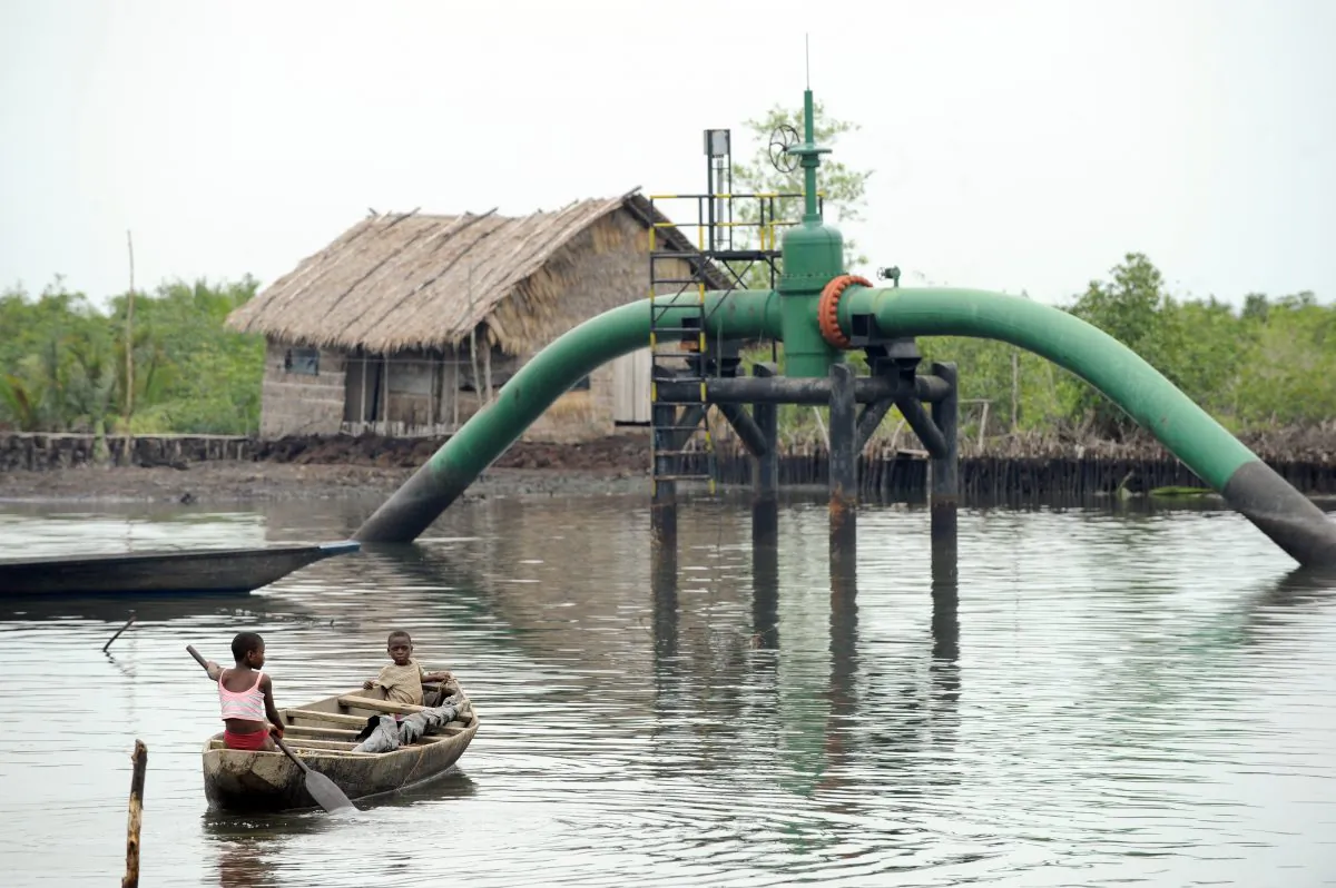 Children sail past an oil pipeline head near their home at Andoni, a settlement in the Rivers State, Nigeria, on April 12, 2011. (Pius Utomi Ekpei/AFP/Getty Images)