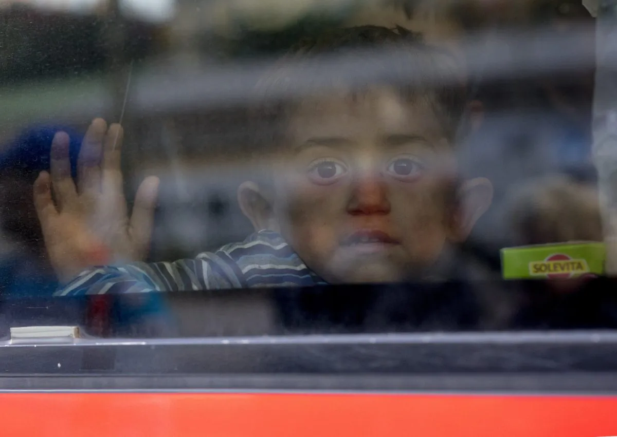 A refugee children waves goodbye, from a train going to Munich, to volunteers who helped them at Vienna's Westbahnhof train station in Vienna, Austria, Sept. 6, 2015. Thousands of migrants and refugees have transited from Hungary via Vienna where they were welcomed and helped by volunteers in the last couple of days. (Joe Klamar/AFP/Getty Images)