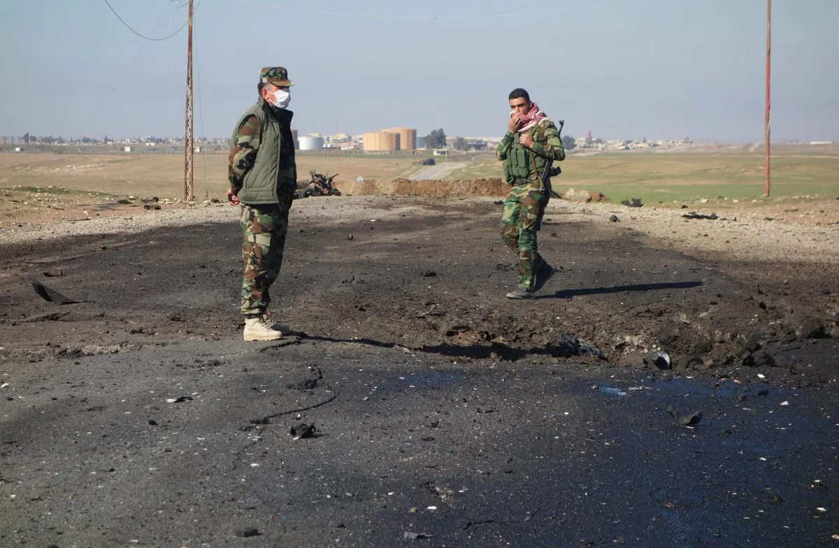 Kurdish soldiers survey the site of a bomb attack on a road between Mosul, Iraq, and the Syrian border in northern Iraq. Kurdish authorities in Iraq said they have evidence the Islamic State used chlorine gas as a chemical weapon against Peshmerga fighters. (Kurdistan Region Security Council/AP)