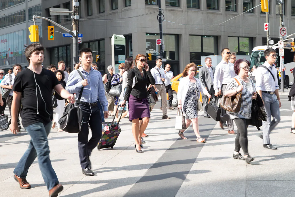 People head to work in Toronto on the morning of July 14, 2015. A new survey suggests many Canadians are pessimistic about their financial futures and expect to work longer than originally planned before retiring. (Photo by Don Quincy)