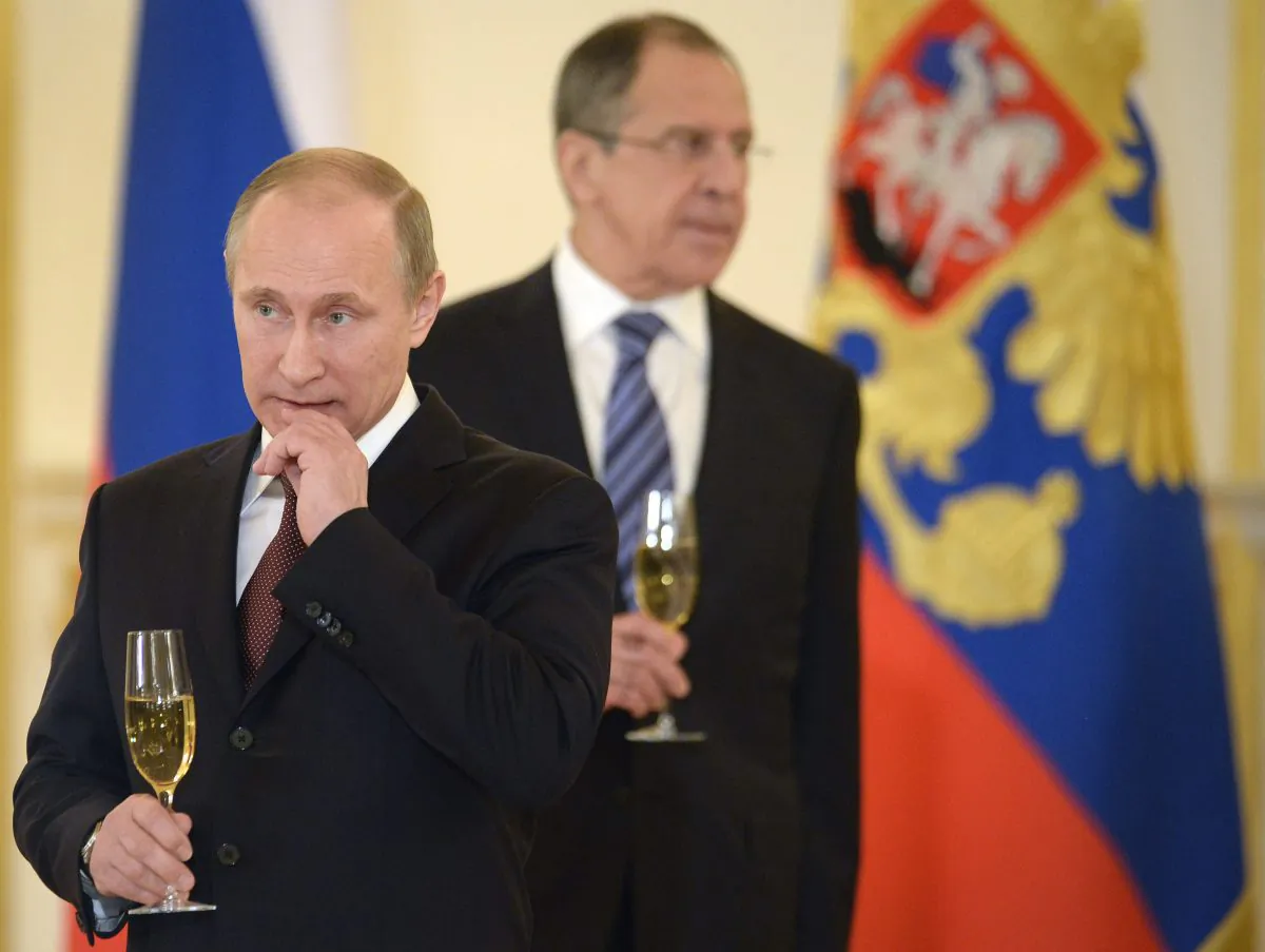 Russia's President Vladimir Putin (L) and Foreign Minister Sergei Lavrov attend a ceremony of receiving foreign ambassadors' credentials in Grand Kremlin Palace in Moscow, on January 16, 2014. (Alexander Nemenov/AFP/Getty Images)