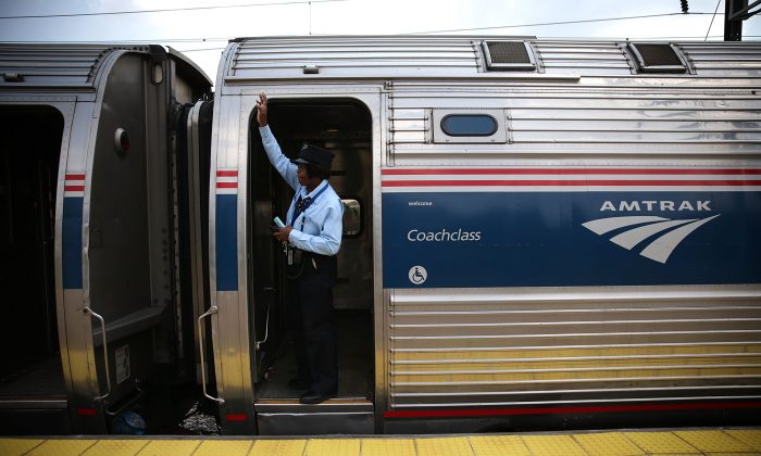 A train conductor signals from an Amtrak train September 3, 2015 in New Carrollton, Maryland. U.S. (Alex Wong/Getty Images)