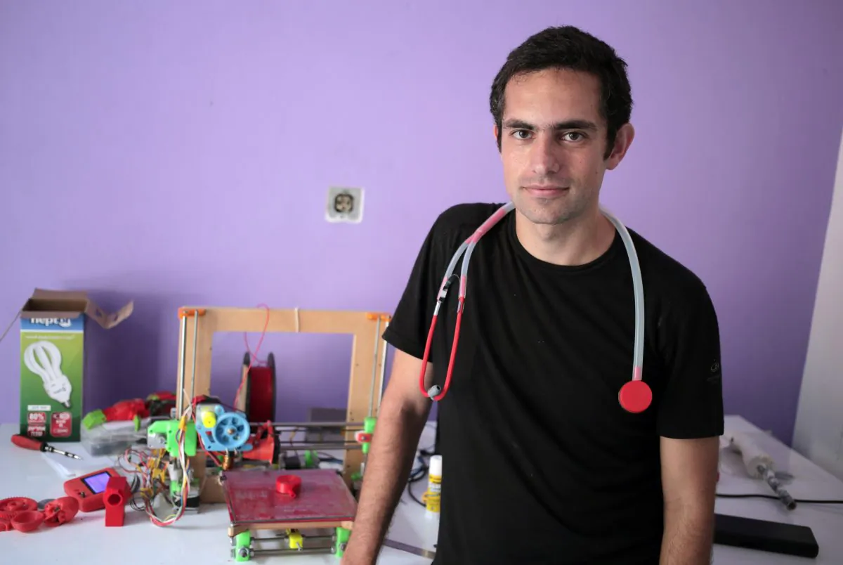 In this Monday, Sept. 7, 2015 photo, Dr. Tarek Loubani, a Palestinian-Canadian doctor, poses for a picture with 3D printed stethoscope around his neck, in Gaza City. (AP Photo/ Khalil Hamra)