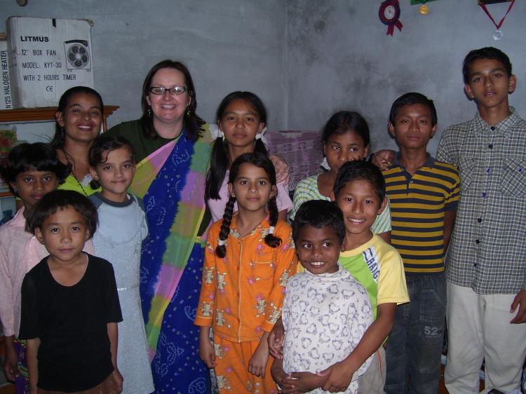Sue van Schreven (fifth from left) is surrounded by happy children as she continues her work with Orphans Aid International. (Photo Courtesy of Sue van Schreven) Sue van Schreven (fifth from left) is surrounded by happy children as she continues her work with Orphans Aid International. (Photo Courtesy of Sue van Schreven)