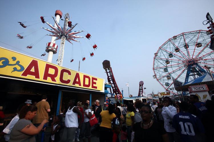 People gather on opening day of the new Luna Park amusement area (L) at Coney Island. (Mario Tama/Getty Images) People gather on opening day of the new Luna Park amusement area (L) at Coney Island. (Mario Tama/Getty Images)