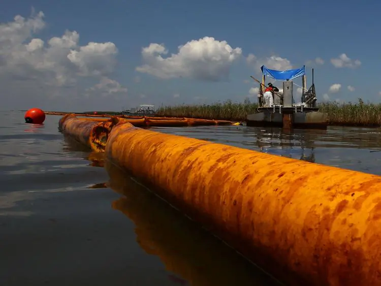 An oil containment boom floats in the water as contract workers from BP use skimmers to clean oil from a marsh near Pass a Loutre, La., on June 1, 2010. (Win McNamee/Getty Images)