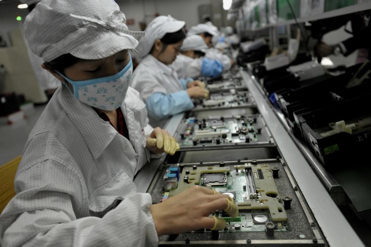 Chinese workers assemble electronic components at the Taiwanese technology giant Foxconn's factory in Shenzhen, in the southern Guangzhou Province, on May 26. (AFP/Getty Images) Chinese workers assemble electronic components at the Taiwanese technology giant Foxconn's factory in Shenzhen, in the southern Guangzhou Province, on May 26. (AFP/Getty Images)