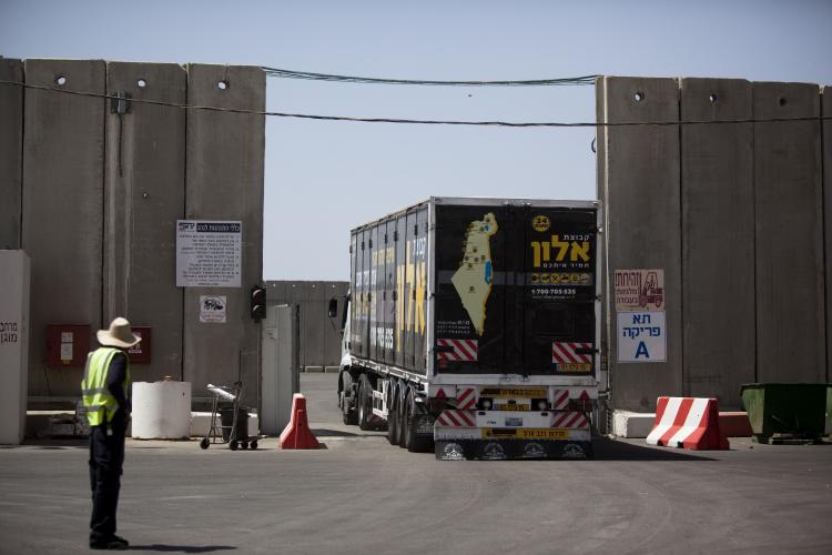 A truck arrives with goods for the Gaza Strip on the border between Gaza and Israel on June 21. On Sunday, Israeli Prime Minister Netanyahu announced details on the easing of restrictions on Gaza. Under the new regulations more goods will be allowed to enter Gaza. (Uriel Sinai/Getty Images) A truck arrives with goods for the Gaza Strip on the border between Gaza and Israel on June 21. On Sunday, Israeli Prime Minister Netanyahu announced details on the easing of restrictions on Gaza. Under the new regulations more goods will be allowed to enter Gaza. (Uriel Sinai/Getty Images)