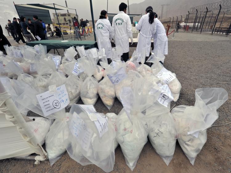 Police crime lab technicians prepare to test samples out of more than 9,000 kilos of drug, mostly cocaine base paste before incinerating it at a police dependency close to Lima on June 22, 2010. Peruvian police incinerated 9,996 kilos of drug Tuesday, which adds to another 14 tons of narcotics, mostly cocaine hydrochloride, incinerated between January and June. 'The confiscation and burning of 14 tons has prevented the circulation of 11 million doses of drug,' said Peruvian Interior Minister Octavio Salazar. (Cris Bouroncle/AFP/Getty Images)