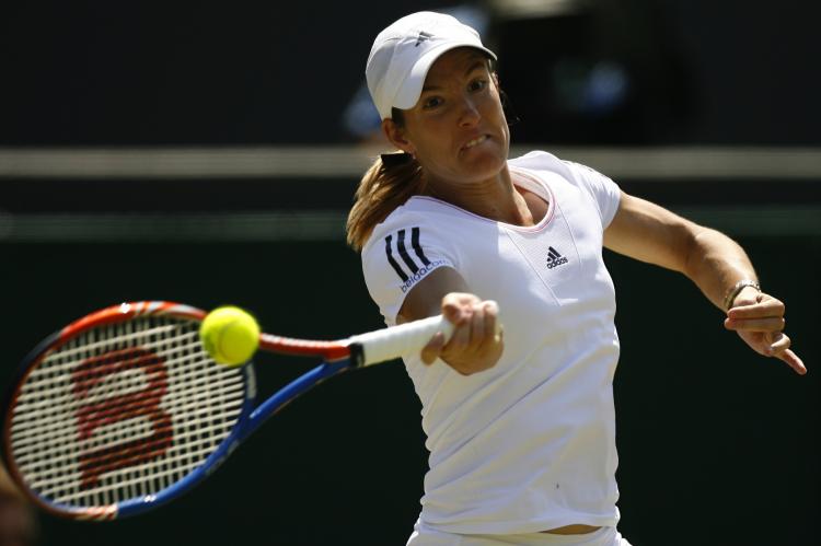 Justine Henin returns a ball to Kim Clijsters during the Wimbledon Tennis Championships on June 28. (Glyn Kirk/AFP/Getty Images) Justine Henin returns a ball to Kim Clijsters during the Wimbledon Tennis Championships on June 28. (Glyn Kirk/AFP/Getty Images)