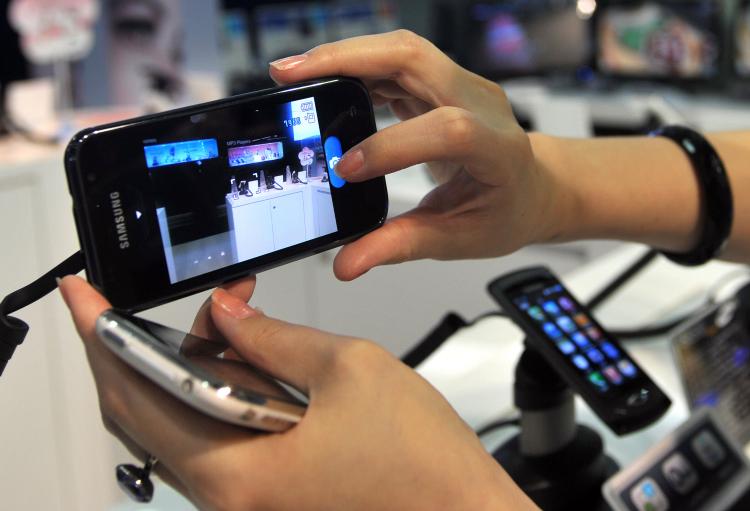 A shopper looks at a smart phone at a shop in Taipei on July 19, 2010. (Patrick Lin/AFP/Getty Images)