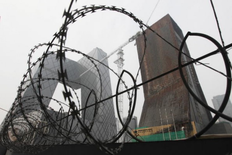 The China Central Television (CCTV) complex is pictured behind a barbed-wire fence in Beijing on Aug. 13, 2010. (Lee/AFP/Getty Images) The China Central Television (CCTV) complex is pictured behind a barbed-wire fence in Beijing on Aug. 13, 2010. (Lee/AFP/Getty Images)