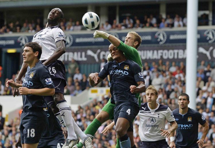 HEAT OF THE BATTLE: Manchester City's Joe Hart (green) punches away a Tottenham cross in Saturday's English Premier League opener. (Ian Kington/AFP/Getty Images) HEAT OF THE BATTLE: Manchester City's Joe Hart (green) punches away a Tottenham cross in Saturday's English Premier League opener. (Ian Kington/AFP/Getty Images)