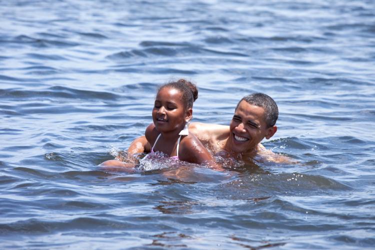 U.S. President Barack Obama and daughter Sasha swim at Alligator Point Aug. 14 in Panama City Beach, Florida. The president traveled to Florida with Michelle Obama and Sasha to meet with local business owners and officials.  (Pete Souza/The White House via Getty Images)