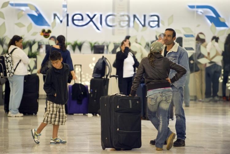Passengers of Mexicana airlines wait for their flight to Spain at the international airport in Mexico City, on August 16, 2010. (Alfredo Estrella/AFP/Getty Images)