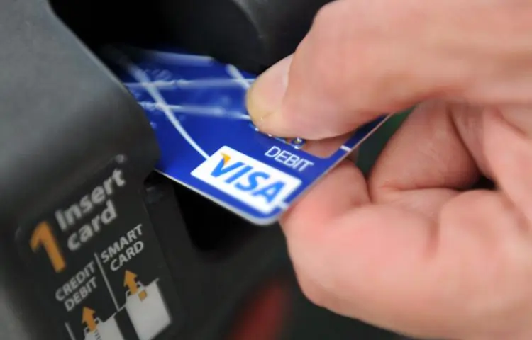 A credit card is swiped at a parking meter on Aug. 20 in Washington. Using a credit card and paying it off is apparently considered "adulting" to some. (Tim Sloan/AFP/Getty Images)