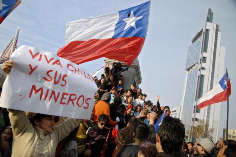 A woman holds a sign reading 'Long live Chile and its miners' as Chileans celebrate in the streets of Santiago after the confirmation of the survival of the 33 trapped miners on August 22.  (Ariel Marinkovic/Getty IMages )