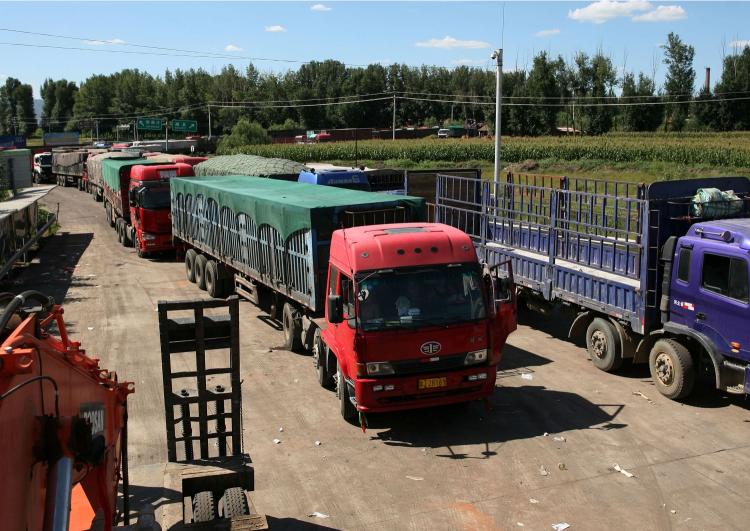 Chinese trucks on the highway leading towards Beijing in Guo Lei Zhuang, north China's Hebei province, on August 23, the ninth day of a 62-mile-long traffic jam leading to Beijng. (STR/AFP/Getty Images) Chinese trucks on the highway leading towards Beijing in Guo Lei Zhuang, north China's Hebei province, on August 23, the ninth day of a 62-mile-long traffic jam leading to Beijng. (STR/AFP/Getty Images)