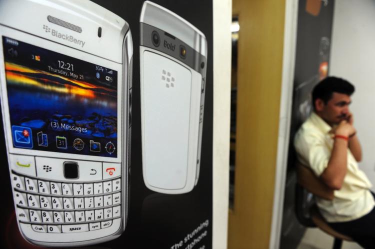 An Indian man speaks on his phone while sitting inside a BlackBerry phone store in Mumbai. BlackBerry manufacturer Research in Motion (RIM) continues to struggle with the Indian government's demand for full access to all data sent by the phones. (Indranil Mukherjee/Getty Images ) An Indian man speaks on his phone while sitting inside a BlackBerry phone store in Mumbai. BlackBerry manufacturer Research in Motion (RIM) continues to struggle with the Indian government's demand for full access to all data sent by the phones. (Indranil Mukherjee/Getty Images )