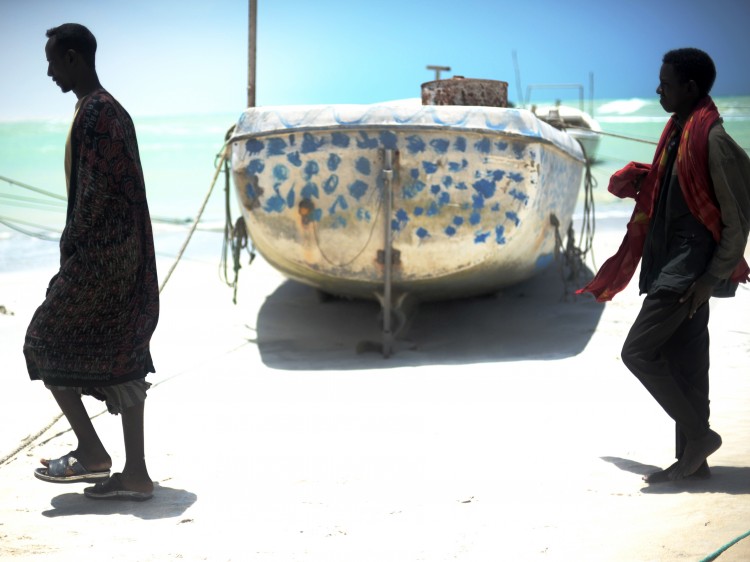 WILD WATERS: Two fishermen, some of the few left in town, walk past a small fishing vessel in the central Somali town of Hobyo. (Roberto Schmidt/AFP/Getty Images) WILD WATERS: Two fishermen, some of the few left in town, walk past a small fishing vessel in the central Somali town of Hobyo. (Roberto Schmidt/AFP/Getty Images)