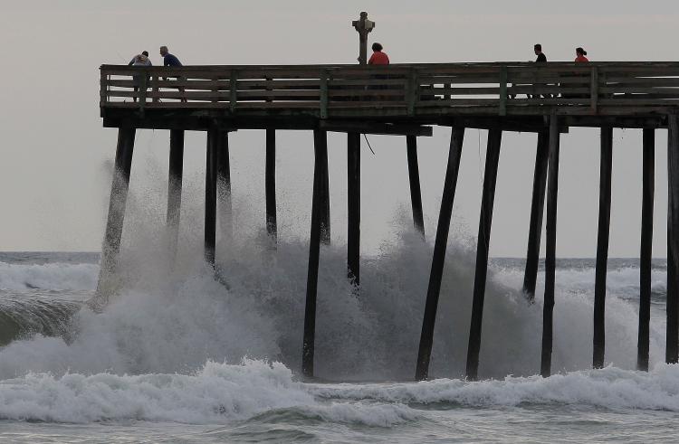 People stand on a pier as Hurricane Earl-induced waves crash below them in Southern Shores, N.C. on on Sept. 2. (Mark Wilson/Getty Images) People stand on a pier as Hurricane Earl-induced waves crash below them in Southern Shores, N.C. on on Sept. 2. (Mark Wilson/Getty Images)