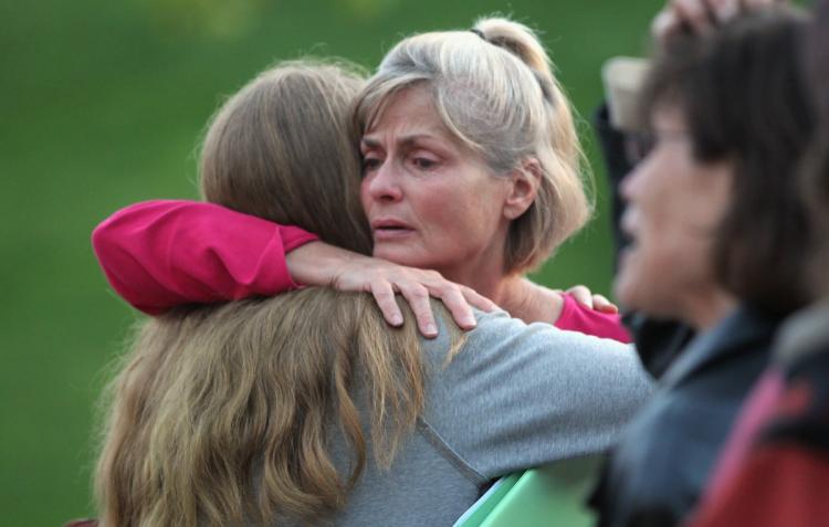 Residents evacuated due to wildfire embrace before a community meeting September 8, in Boulder, Colorado. More than 140 structures, many of them houses, were destroyed, along with 6,000 acres burnt in the Fourmile Canyon fire to the west of Boulder. (John Moore/Getty Images) Residents evacuated due to wildfire embrace before a community meeting September 8, in Boulder, Colorado. More than 140 structures, many of them houses, were destroyed, along with 6,000 acres burnt in the Fourmile Canyon fire to the west of Boulder. (John Moore/Getty Images)