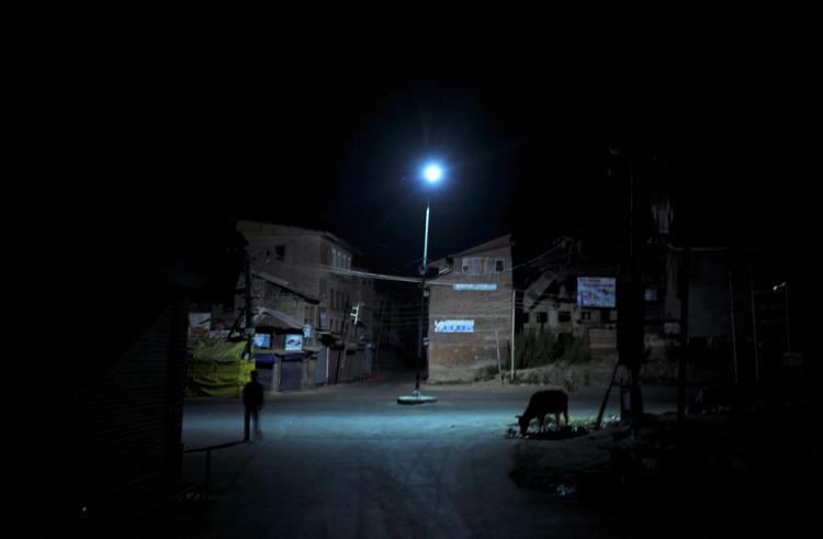 A man walks past a cow grazing in a deserted street of Srinagar on September 12, 2010. Authorities imposed an indefinite curfew in Srinagar and other Jammu and Kashmir towns today, a day after the city saw widespread violent protests. (Sajjad Hussain/Getty Images ) A man walks past a cow grazing in a deserted street of Srinagar on September 12, 2010. Authorities imposed an indefinite curfew in Srinagar and other Jammu and Kashmir towns today, a day after the city saw widespread violent protests. (Sajjad Hussain/Getty Images )