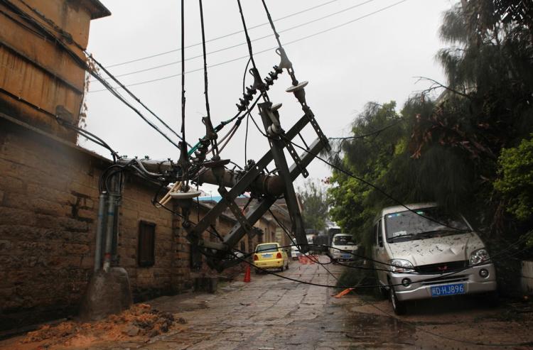A fallen electric pole lies across a street in Xiamen, southeast China's Fujian province, on September 20. China warned of flash floods and landslides as Typhoon Fanapi made landfall on the mainland, one day after slamming Taiwan with heavy rains, which left more than 100 injured on the island. (STR/Getty Images) A fallen electric pole lies across a street in Xiamen, southeast China's Fujian province, on September 20. China warned of flash floods and landslides as Typhoon Fanapi made landfall on the mainland, one day after slamming Taiwan with heavy rains, which left more than 100 injured on the island. (STR/Getty Images)