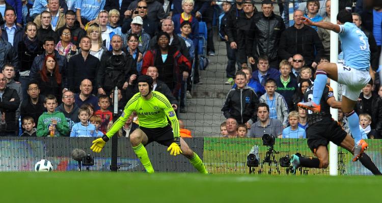 Man City's Argentinian striker Carlos Tevez (R) shoots past Chelsea's Czech goalkeeper Petr Cech to score the only goal of the English Premier League football match at the City Of Manchester Stadium in Manchester, Sept. 25. (Andrew Yates/AFP/Getty Images) Man City's Argentinian striker Carlos Tevez (R) shoots past Chelsea's Czech goalkeeper Petr Cech to score the only goal of the English Premier League football match at the City Of Manchester Stadium in Manchester, Sept. 25. (Andrew Yates/AFP/Getty Images)