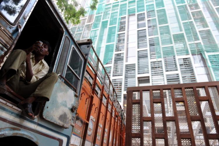 A worker checks his mobile phone, at the entrance of the twenty-seven storey Antilia, the newly-built residence. (Indranil Mukherjee/AFP/Getty Images) A worker checks his mobile phone, at the entrance of the twenty-seven storey Antilia, the newly-built residence. (Indranil Mukherjee/AFP/Getty Images)