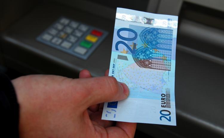 A person withdrawing money from an ATM in Dublin, Ireland, on November 22. (Peter Muhly/Getty Images)