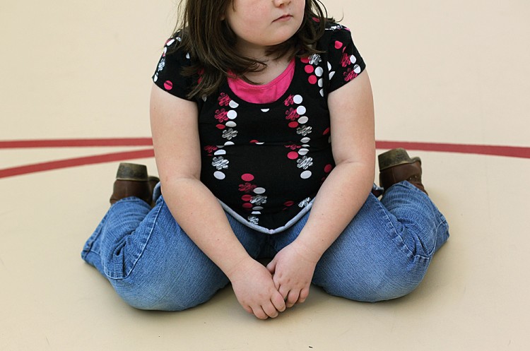 A child sits on the gym floor during a workout. (John Moore/Getty Images) A child sits on the gym floor during a workout. (John Moore/Getty Images)