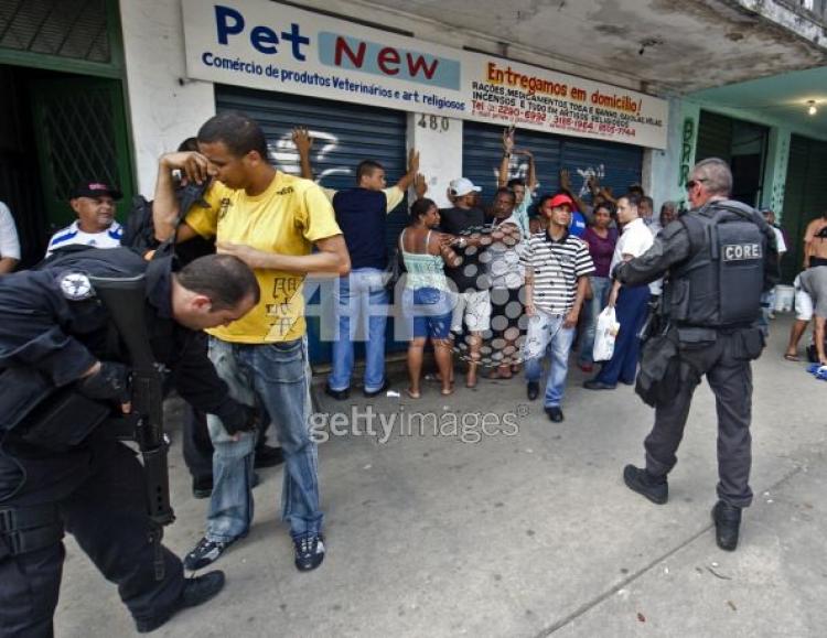 Riot agents search Vila Cruzeiro shantytown's residents on Nov. 25, in Rio de Janeiro, Brazil.(Antonio Scorza/AFP/Getty Images)
