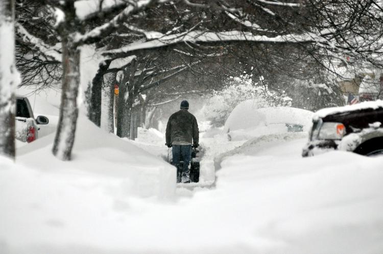 A resident begins to dig out after a five mile wide band of lake effect snow dumped more than two feet of snow and closed a 16-mile stretch of the New York State Thruway December 2, in Buffalo, New York. (John Normile/Getty Images ) A resident begins to dig out after a five mile wide band of lake effect snow dumped more than two feet of snow and closed a 16-mile stretch of the New York State Thruway December 2, in Buffalo, New York. (John Normile/Getty Images )