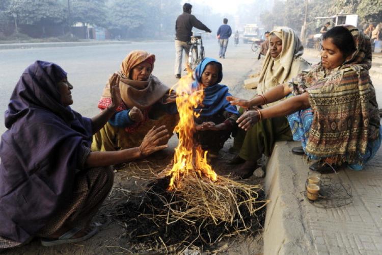 Indian street sweepers warm themselves as they sit around a bonfire on a roadside in Amritsar on Dec. 3, 2010. (Narinder Nanu/AFP/Getty Images) Indian street sweepers warm themselves as they sit around a bonfire on a roadside in Amritsar on Dec. 3, 2010. (Narinder Nanu/AFP/Getty Images)