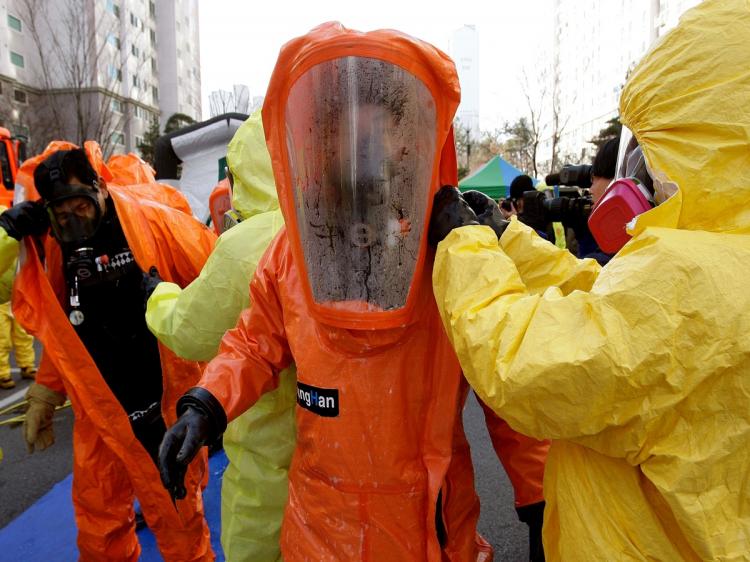 Emergency service personnel in chemical protection clothing participate in a civil defense exercise on December 15, 2010 in Paju, South Korea. (Chung Sung-Jun/Getty Images) Emergency service personnel in chemical protection clothing participate in a civil defense exercise on December 15, 2010 in Paju, South Korea. (Chung Sung-Jun/Getty Images)