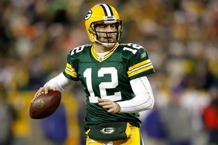 Aaron Rodgers #12 of the Green Bay Packers rolls out of the pocket against the New York Giants at Lambeau Field on December 26, 2010 in Green Bay, Wisconsin. (Matthew Stockman/Getty Images)