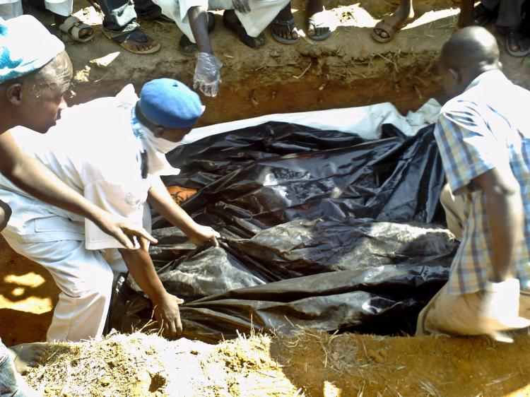Bodies of people killed in the recent bomb attacks are buried on Dec. 27 at the Naraguta cemetery in Jos, Nigeria. A coordinated attack of four bombs in Jos on Christmas Eve took at least 80 lives. (Aminu AbuBakar/AFP/Getty Images) Bodies of people killed in the recent bomb attacks are buried on Dec. 27 at the Naraguta cemetery in Jos, Nigeria. A coordinated attack of four bombs in Jos on Christmas Eve took at least 80 lives. (Aminu AbuBakar/AFP/Getty Images)