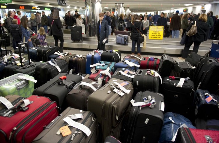 Unclaimed bags in the foreground as trav Epoch Times Photo