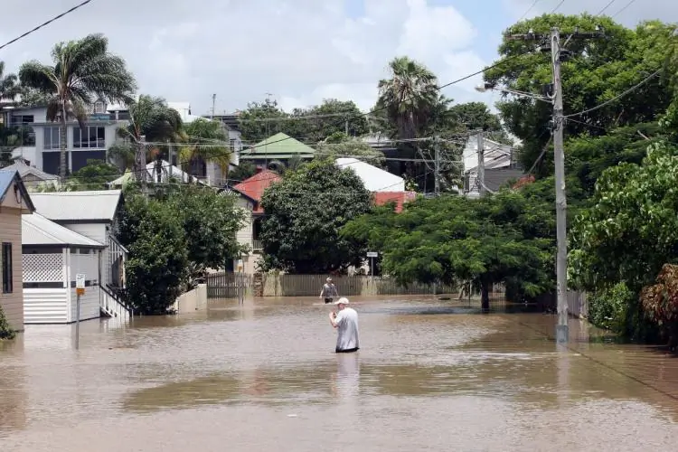 Residents brave the flood waters brought by the La Nina weather cycle in Brisbane, Australia, on Jan. 12, 2011. (Bradley Kanaris/Getty Images)