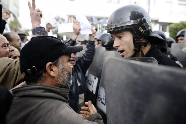 A Tunisian protester talks to a policemen during a demonstration. (Fred Dufour/AFP/Getty Images)