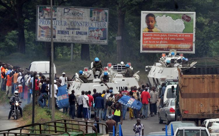 Supporters of incumbent Ivorian President Laurent Gbagbo block a convoy of UN peacekeepers on January 24 in Abidjan. Alassane Ouattara, internationally recognized as the winner of Ivory Coast's election, tried to choke off funding for his rival Laurent Gbagbo on Monday by ordering a halt to cocoa and coffee exports. (Issouf Sanogo/Getty Images )