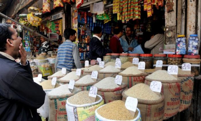 Indian customers purchase grains from a shop at a market in New Delhi, India, on Feb. 16, 2015. Rising food prices will put more than 40 million people in poverty if left unchecked, World Bank says. (Raveendran/AFP/Getty Images)