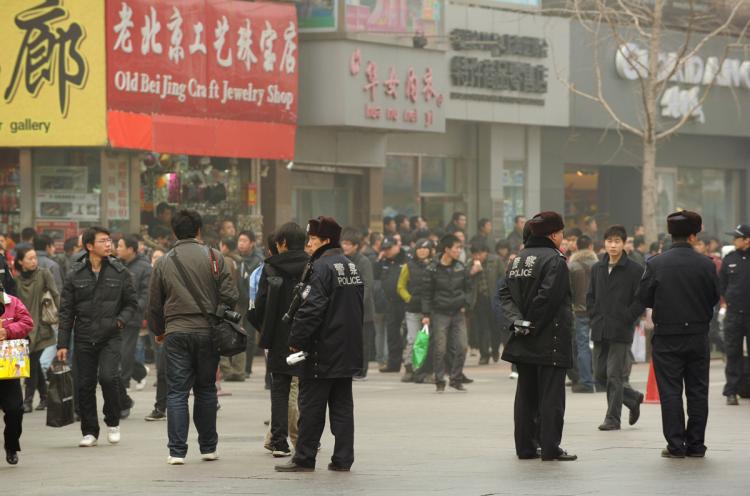 Police keep watch along the Wanfujing shopping street in Beijing after protesters gathered on February 20, 2011. A website claiming to represent China's homegrown Jasmine Revolution has called on the populace to take to the streets, every Saturday at 6:00pm.   (Peter Parks/Getty Images)