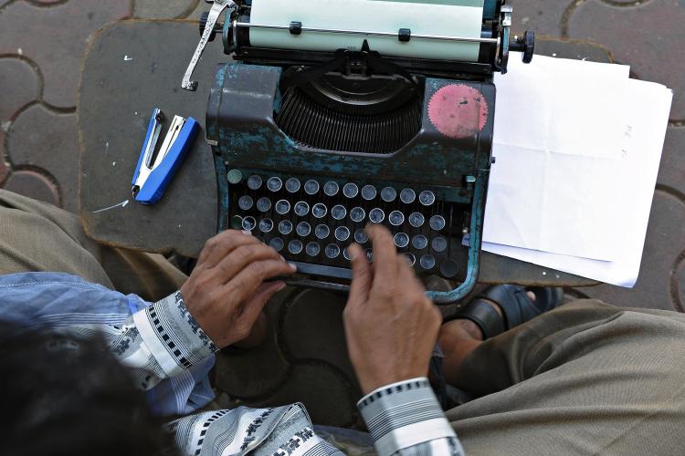 Professional typist Purushottam Sakhare typing an affidavit on his typewriter at a sidewalk outside a city court in Mumbai on Feb. 15. (Indranil Mukherjee/AFP/Getty Images) Professional typist Purushottam Sakhare typing an affidavit on his typewriter at a sidewalk outside a city court in Mumbai on Feb. 15. (Indranil Mukherjee/AFP/Getty Images)