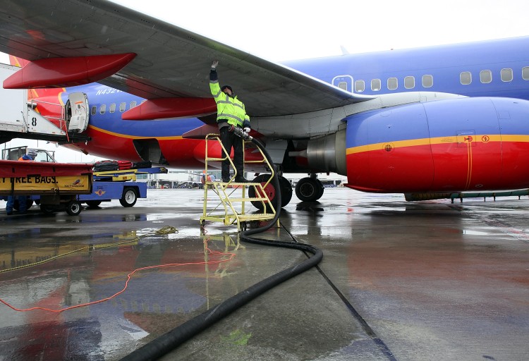Swissport employee Miroslaw Kaczorowski prepares to refuel a Southwest Airlines plane at the Oakland International Airport on February 24, 2011 in Oakland, California. (Justin Sullivan/Getty Images)
