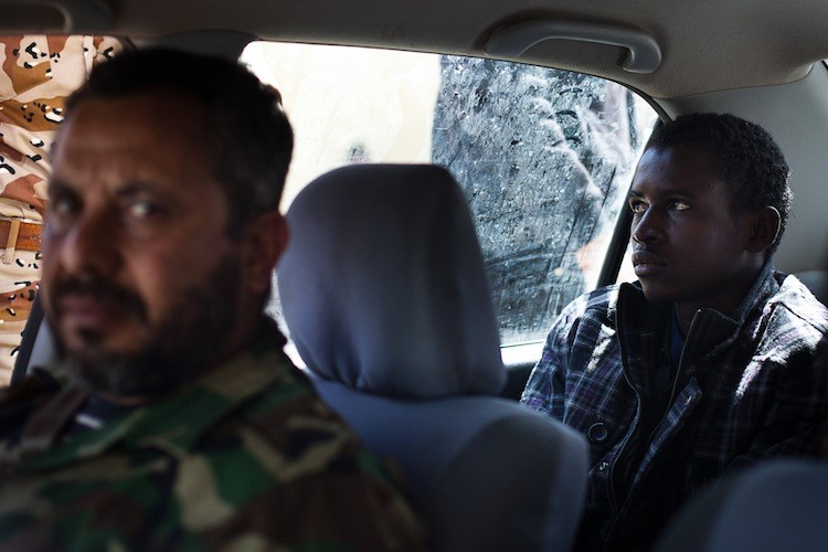 A Libyan rebel fighter detains a captured alleged mercenary in a car as he waits to be transported from Ajdabiya to Benghazi on March 3. (Trevor Snapp/AFP/Getty Images) A Libyan rebel fighter detains a captured alleged mercenary in a car as he waits to be transported from Ajdabiya to Benghazi on March 3. (Trevor Snapp/AFP/Getty Images)