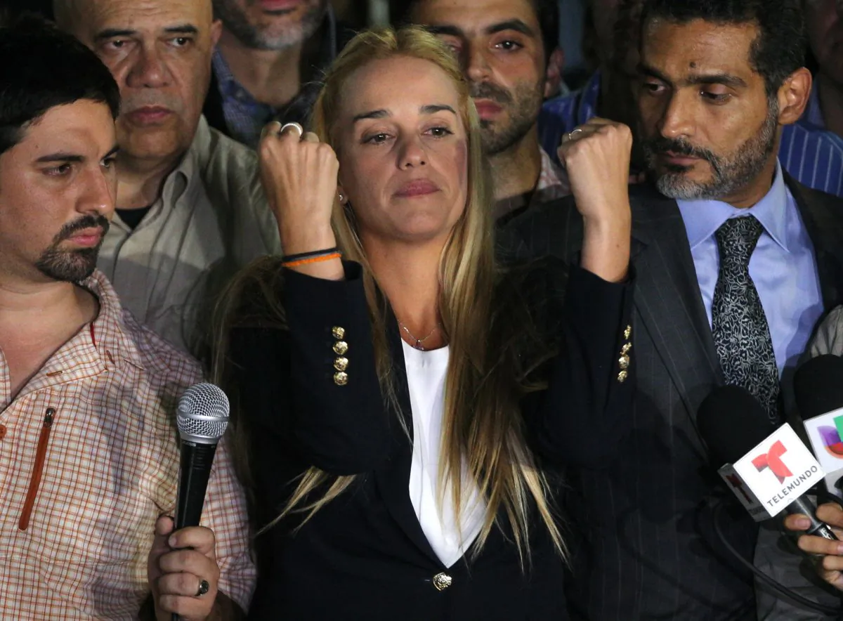 Lilian Tintori, wife of jailed opposition leader Leopoldo Lopez, center, gestures during a news conference at Bolivar square in Chacao municipality, in Caracas, Venezuela, Thursday, Sept. 10, 2015. (AP Photo/Fernando Llano)