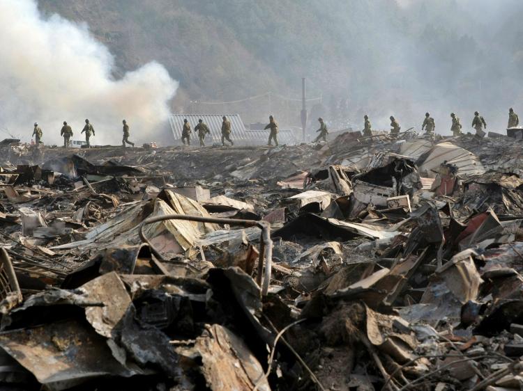 Self Defence troops walk through debris to search for missing people at Otsuchi town in Iwate prefecture on March 13, 2011. Japanese authorities warned on Sunday that the Fukushima Daiichi No. 3 Reactor could explode. (Jiji Press/AFP/Getty Images) Self Defence troops walk through debris to search for missing people at Otsuchi town in Iwate prefecture on March 13, 2011. Japanese authorities warned on Sunday that the Fukushima Daiichi No. 3 Reactor could explode. (Jiji Press/AFP/Getty Images)