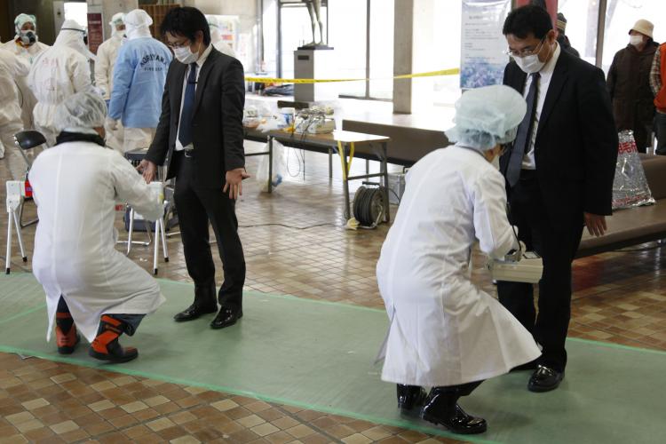 Businessmen receive radiation scans at a screening centre in Koriyama in Fukushima prefecture, 60km west of TEPCO's striken Fukushima No.1 nuclear power plant, on March 18, 2011.  (Go Takayama/AFP/Getty Images)